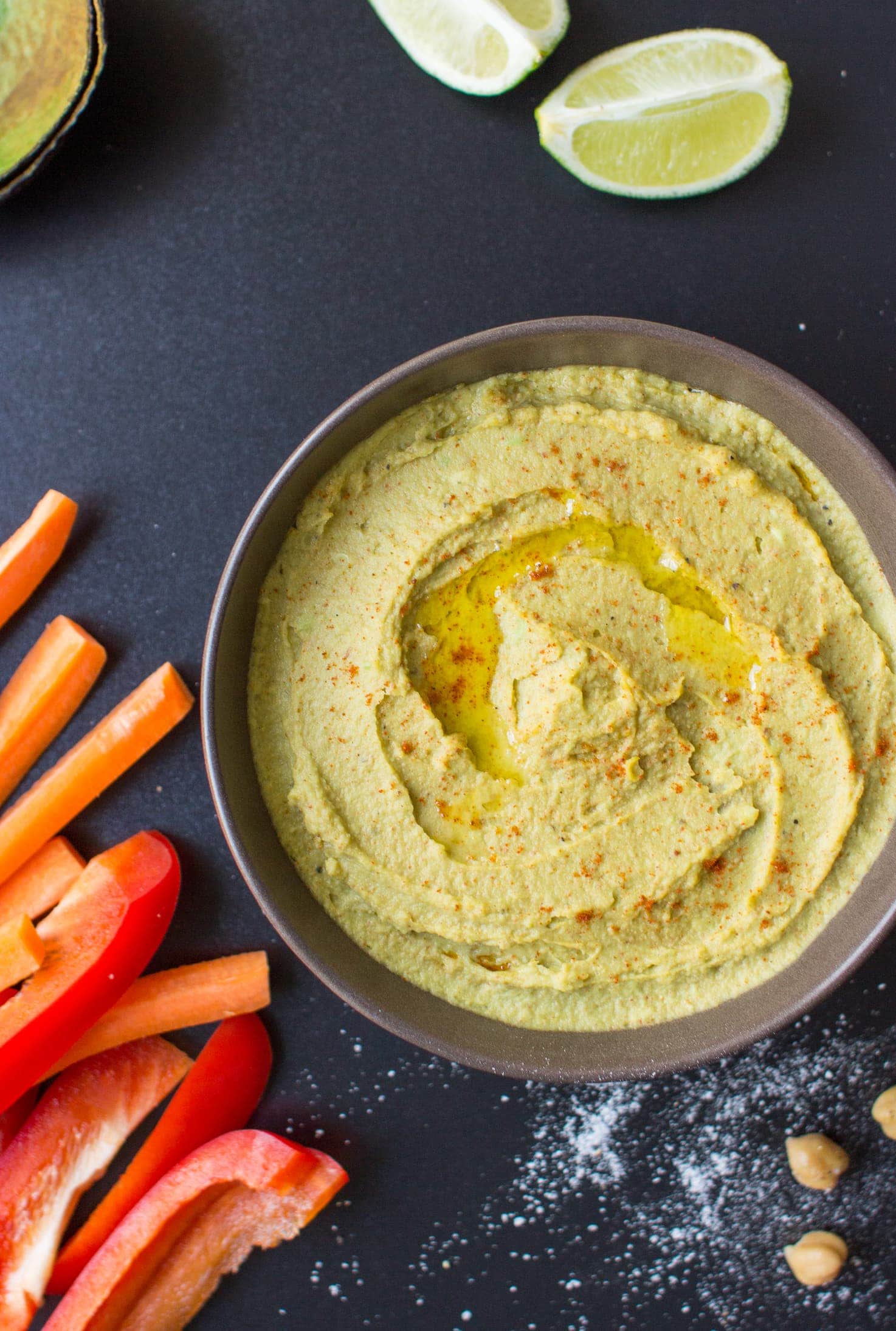 Avocado Hummus is in a bowl alongside the veggie sticks and lemon wedges | Hurry The Food Up