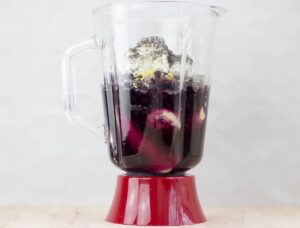 A blender with ingredients for blueberry banana protein smoothie | HurryTheFoodUp