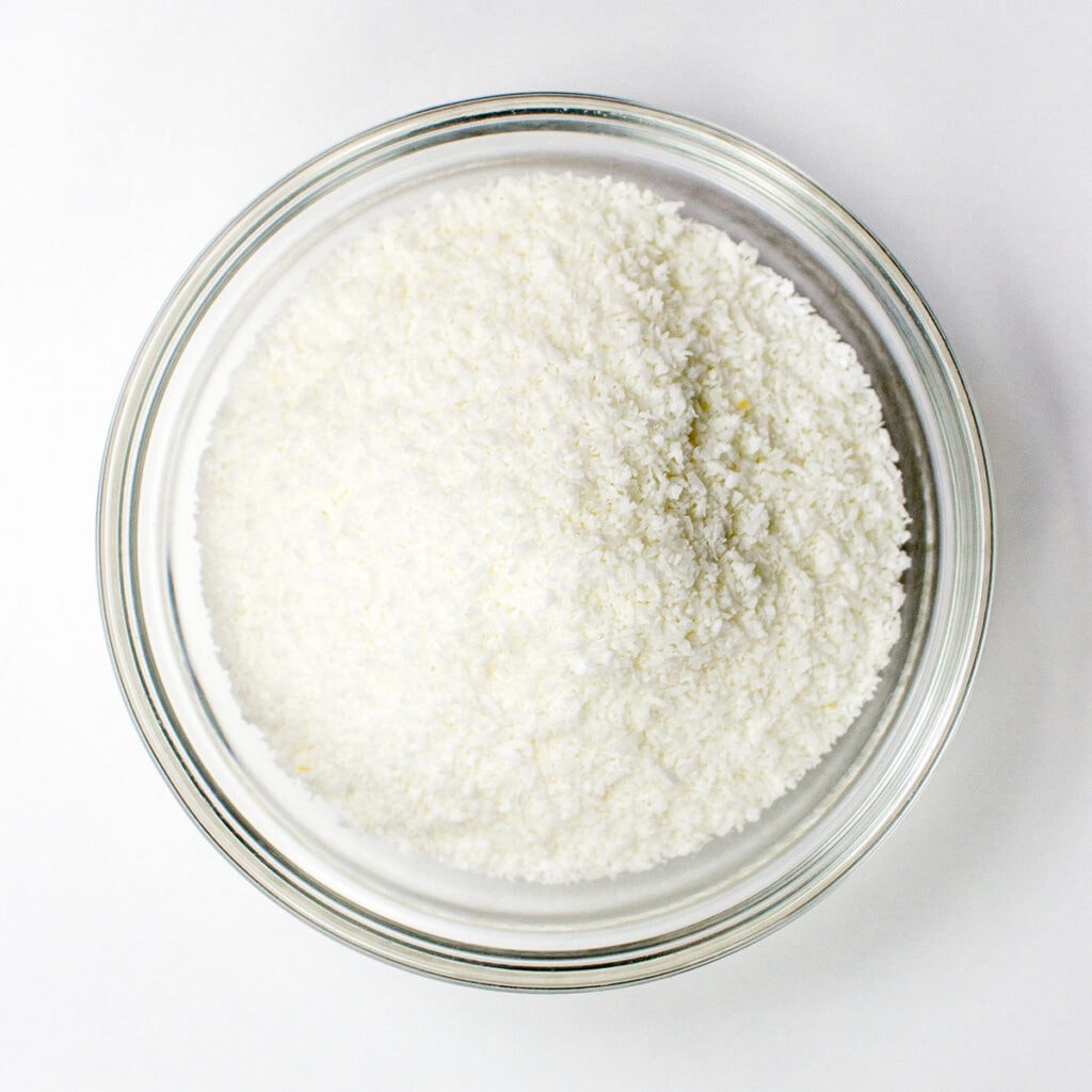 Coconut flakes on white background