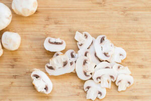 Chopped mushrooms are on the cut board | Hurry The Food Up