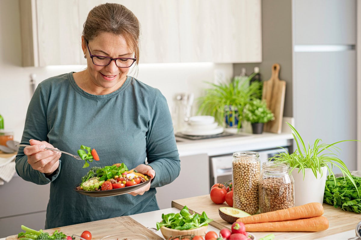 The woman eats salad in the kitchen | Hurry The Food Up