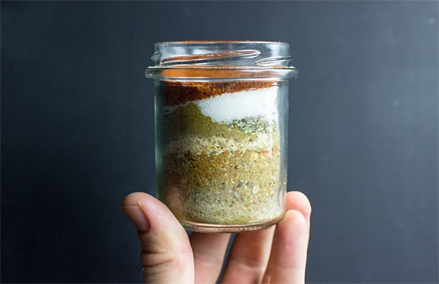 The hand is holding the jar with seasoning | Hurry The Food Up