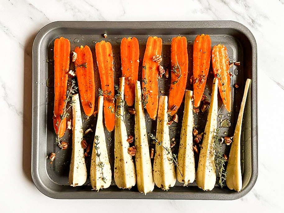 All the ingredients are placed on a baking tray #parsnips #feta | 