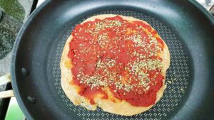 Tomato sauce and dried herbs are layered over the base #flour #olive oil | 