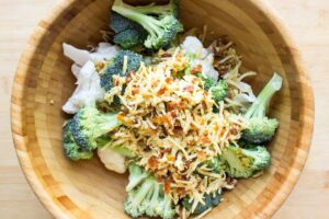 All the ingredients for oven roasted broccoli and cauliflower are in a wooden bowl | Hurry The Food Up
