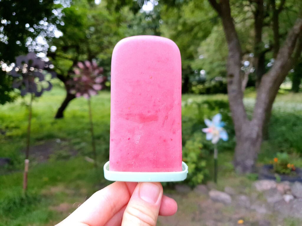 Strawberry popsicle in a hand