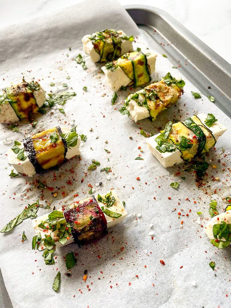 Vegetable blankets are wrapped around the halloumi pig and placed on a baking tray #aubergine #lemon juice | 