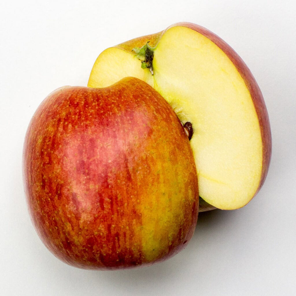 Two apple halves on white background