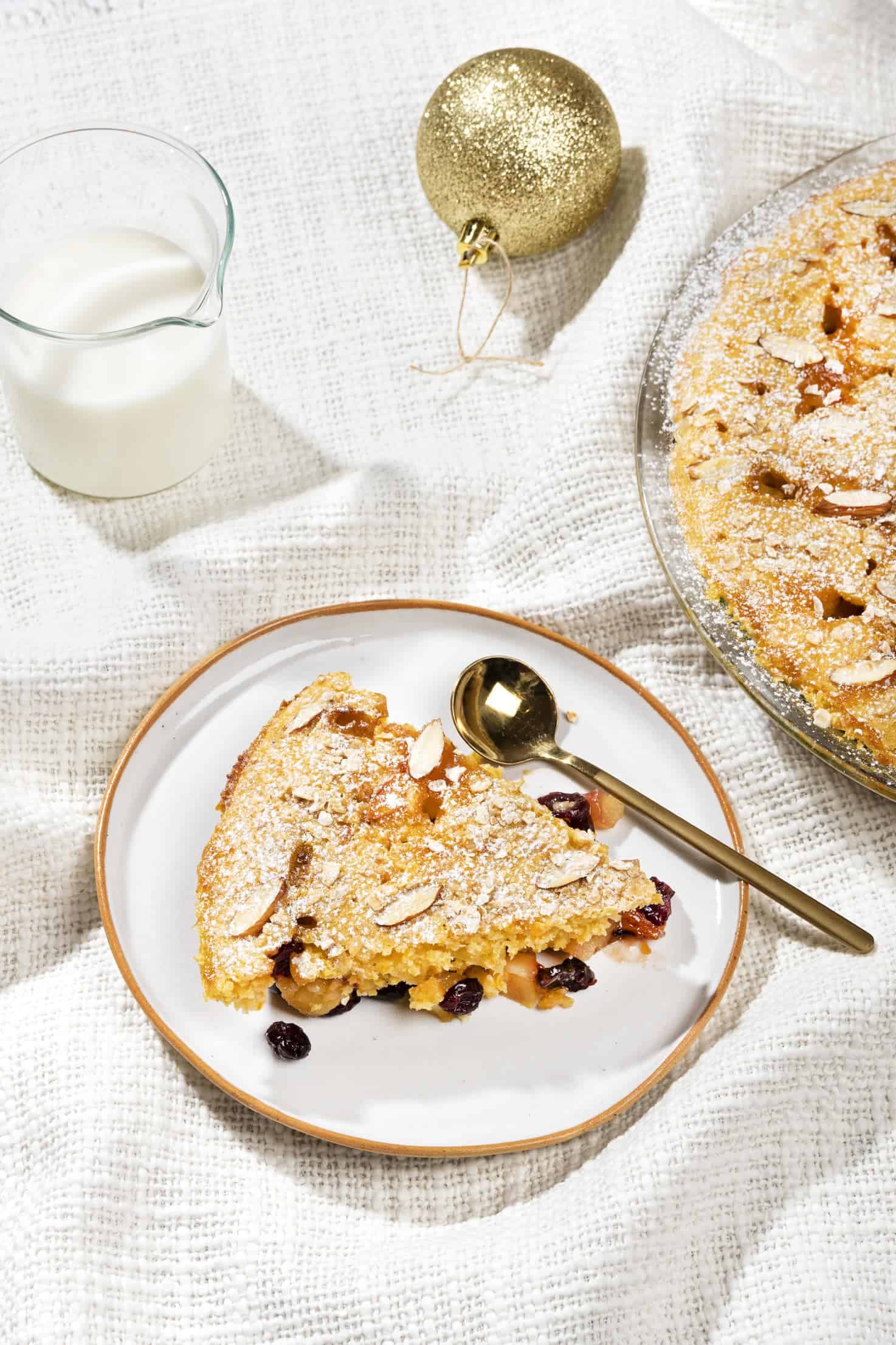 A slice of apple breakfast bake alongside a glass of milk. | Hurry The Food Up