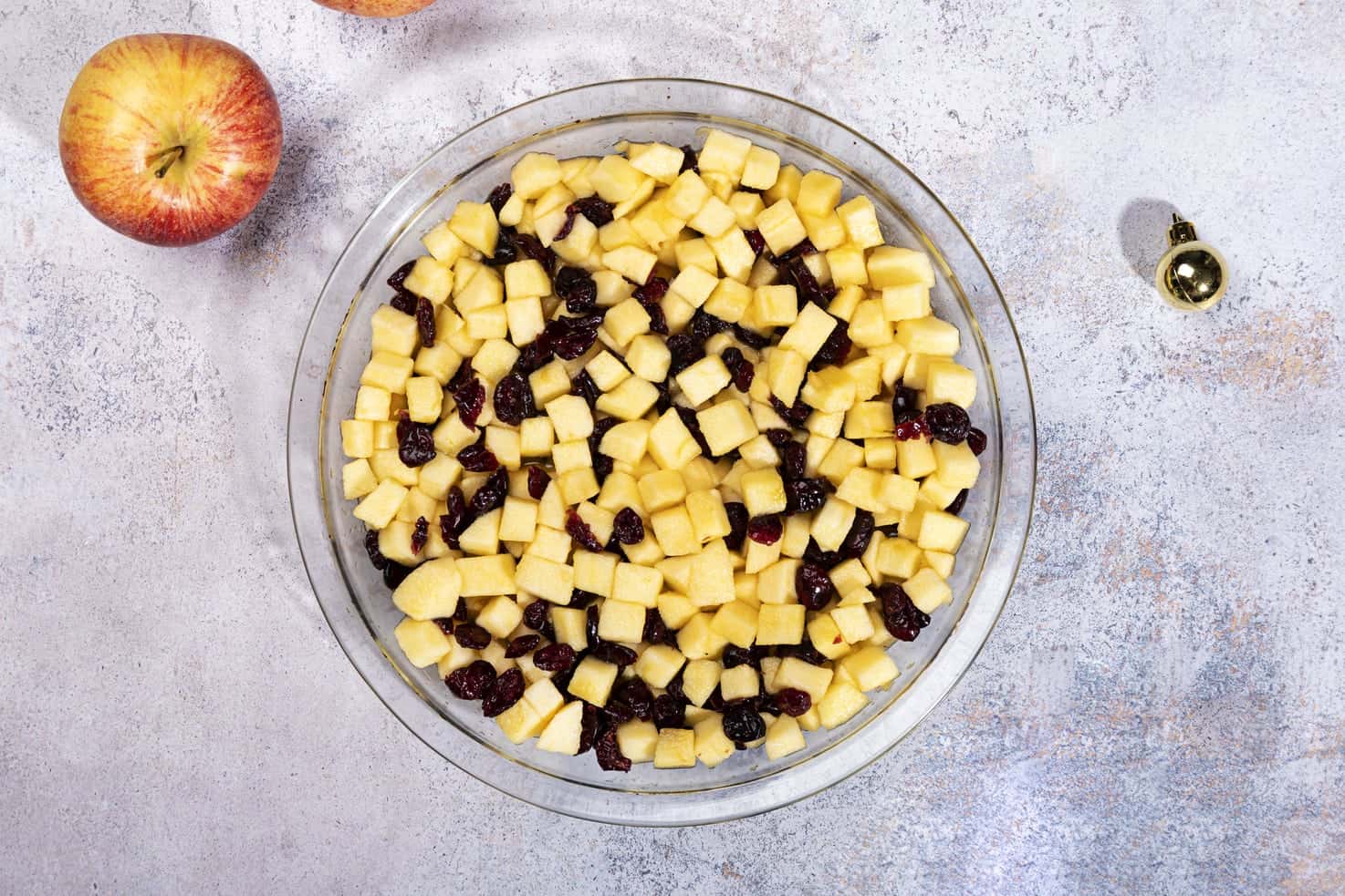 Chopped up apples and cranberries in a bowl, ready to be used in the cake. | Hurry The Food Up