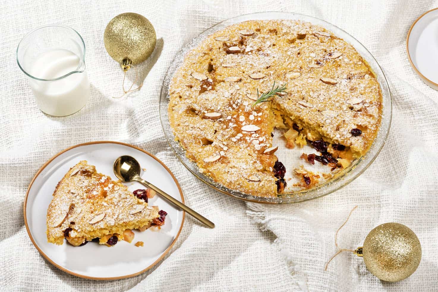 The apple breakfast bake is served in a glass tray. A slice has been cut out and served on a plate. | Hurry The Food Up