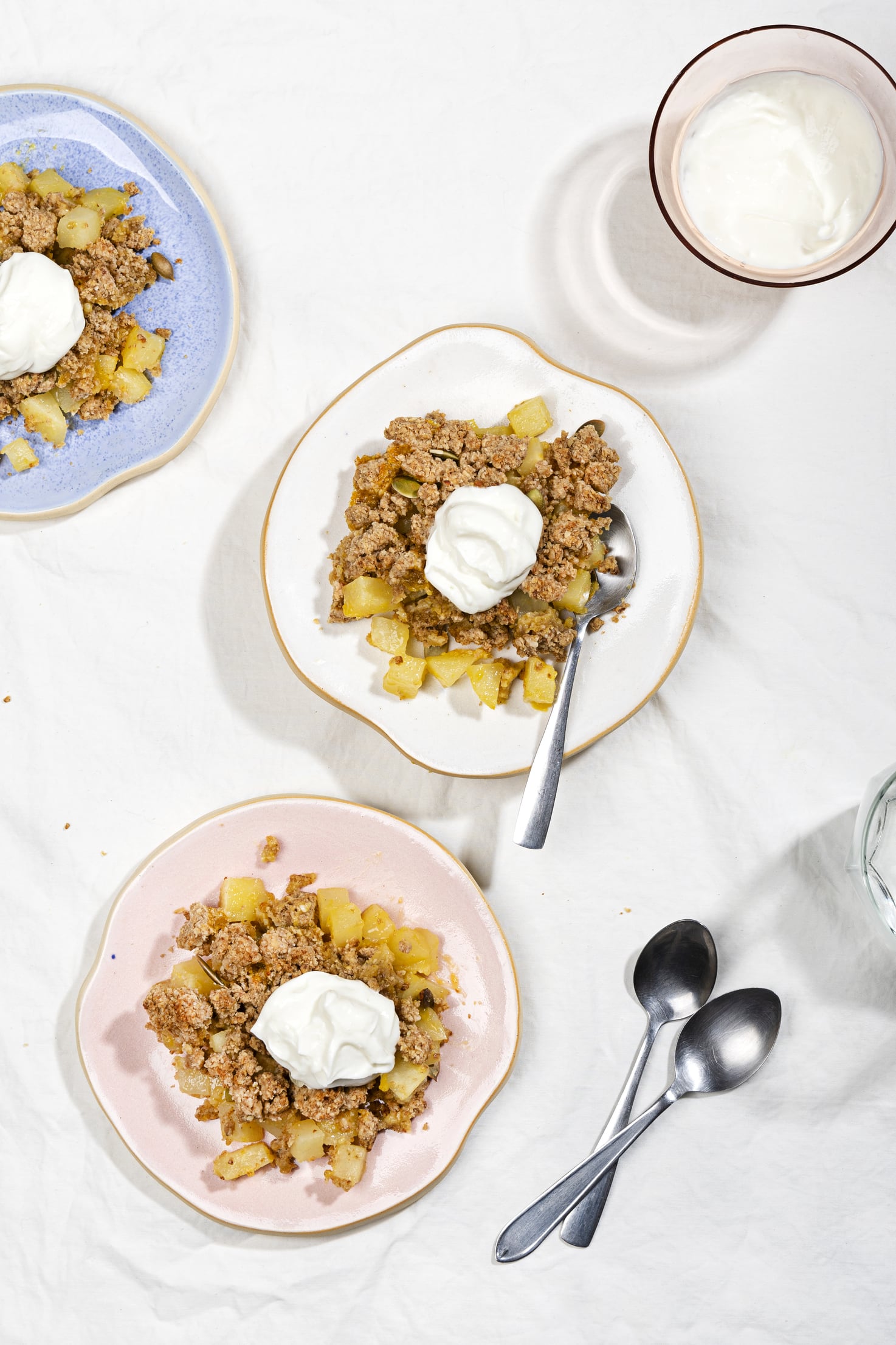 A birds eye view of two plates of healthy pear crisp. | Hurry The Food Up