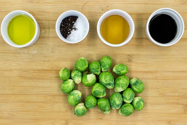Brussel sprouts and ingredients for balsamic glaze on a chopping board