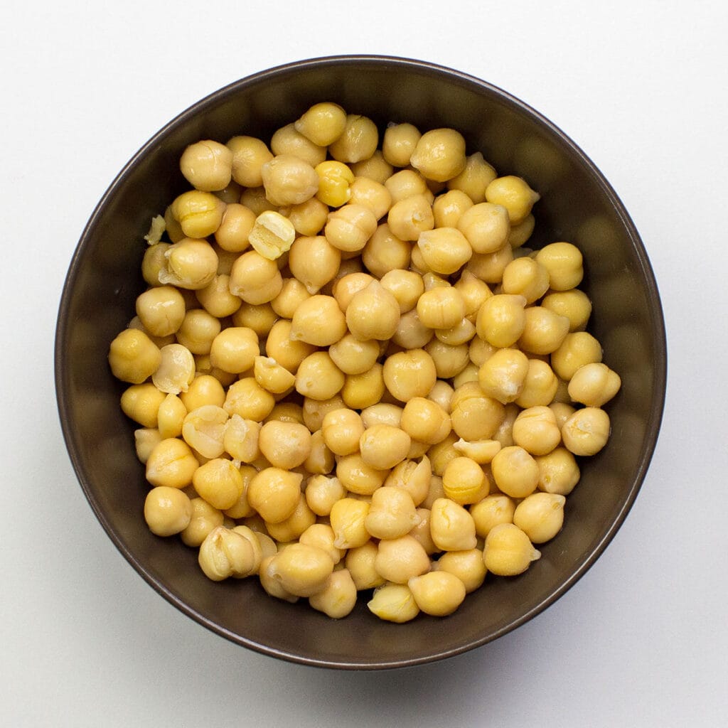 A bowl of chickpeas on white surface