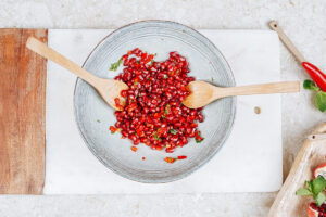 Mixing the ingredients for pomegranate salsa in the grey bowl | Hurry The Food Up