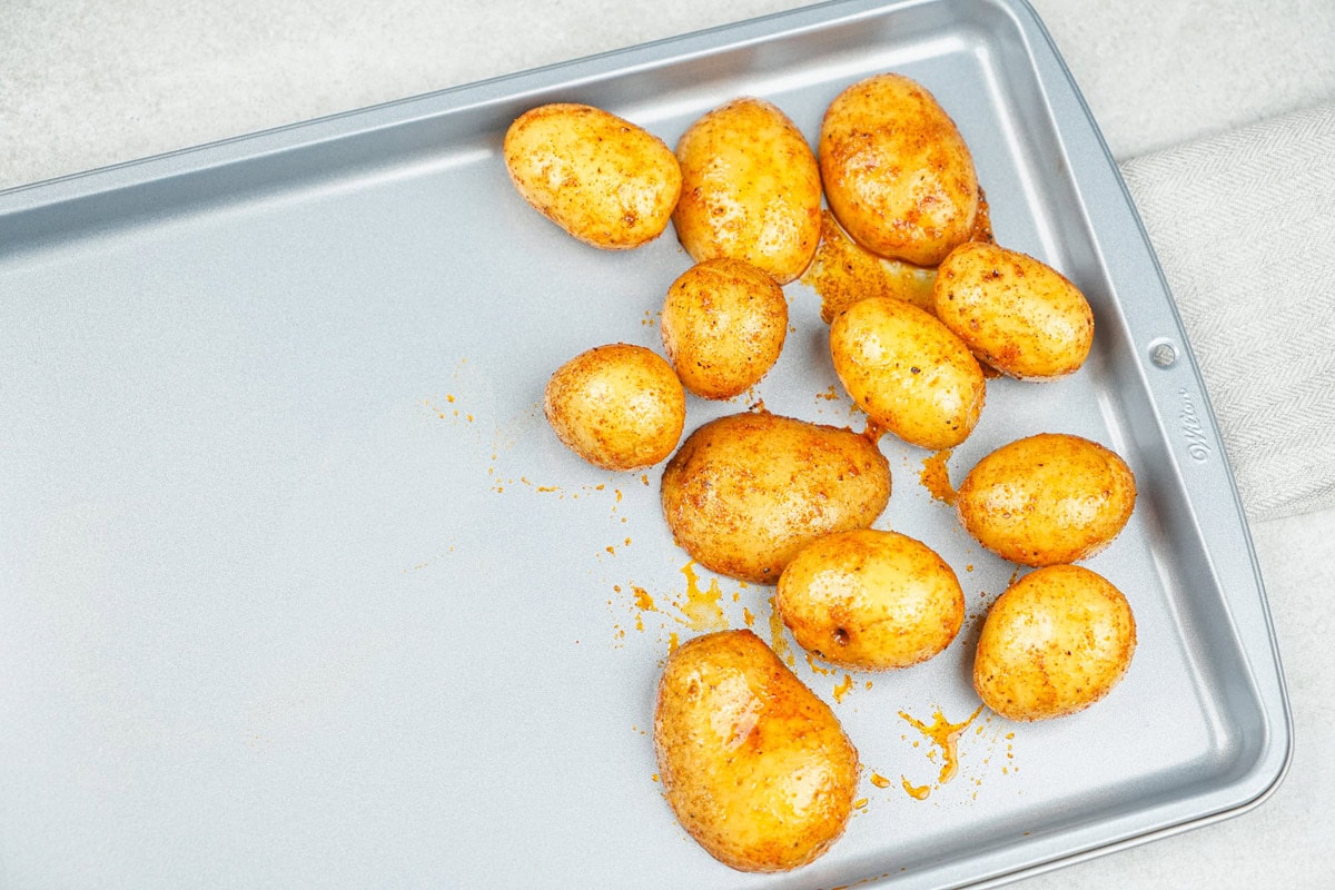 The process of arranging potatoes on one side of a baking sheet | Hurry The Food Up