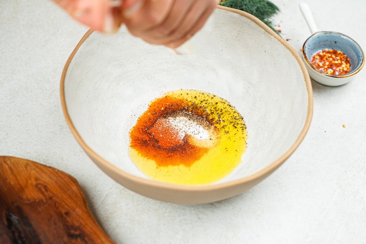 The process of mixing the olive oil, sweet paprika, salt and pepper | Hurry The Food Up
