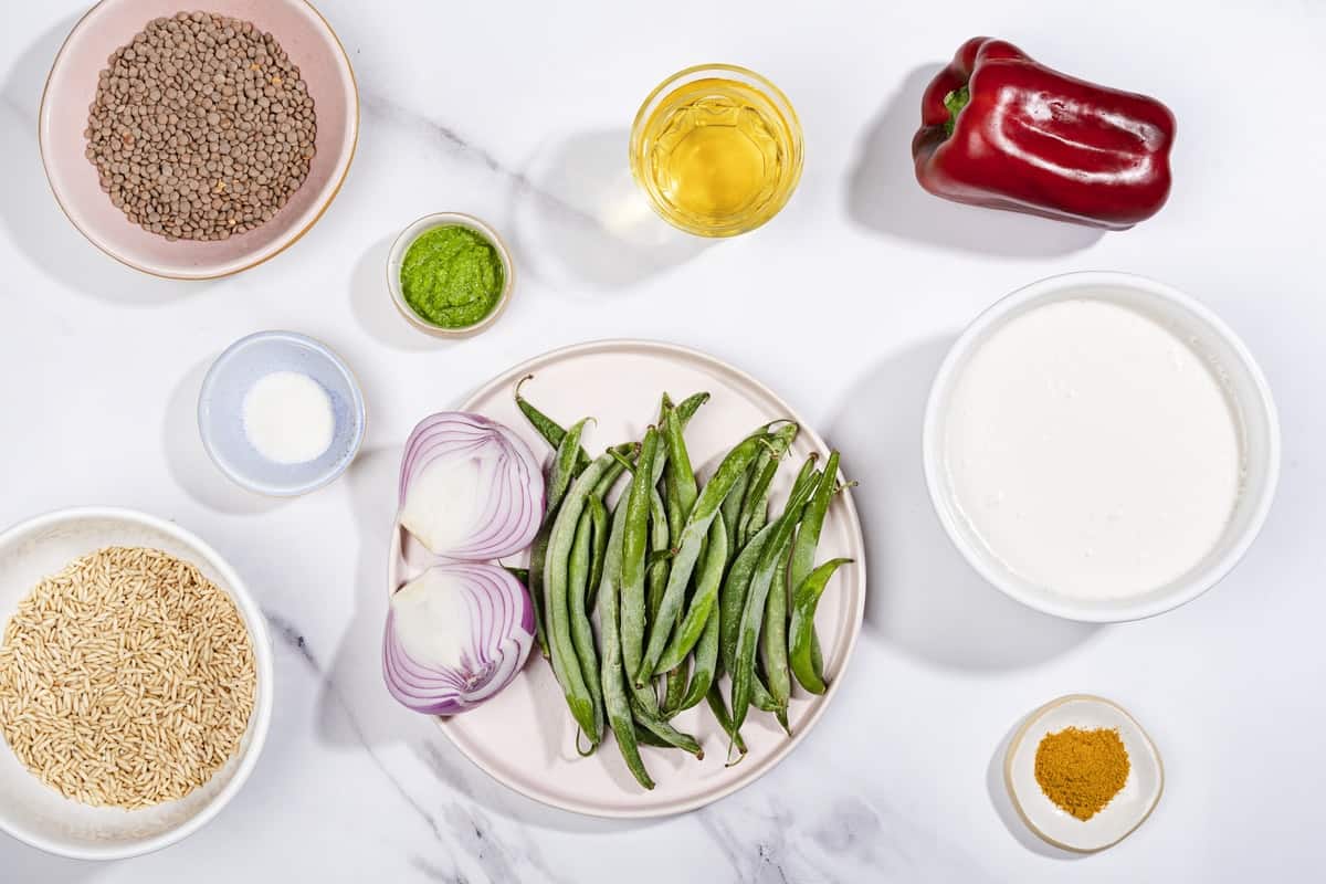 A birds eye view of the ingredients for curried lentil soup, including pepper, green beans, & lentils. | Hurry The Food Up