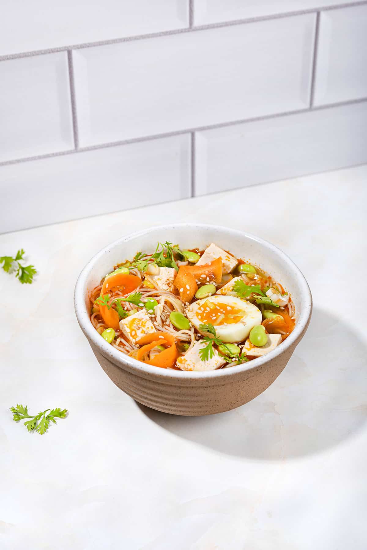 An easy homemade ramen noodle soup is served in the bowl that is on a white table | Hurry The Food Up