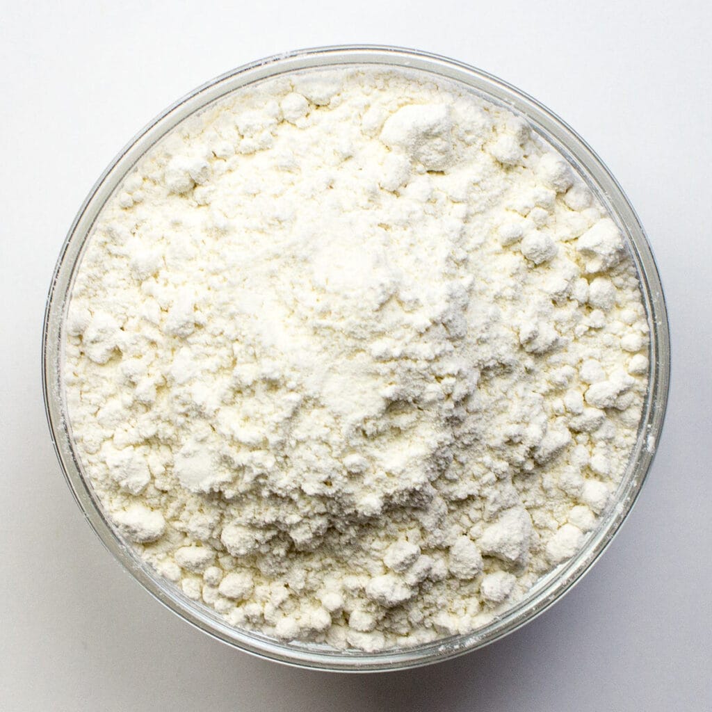 A bowl of flour on white background