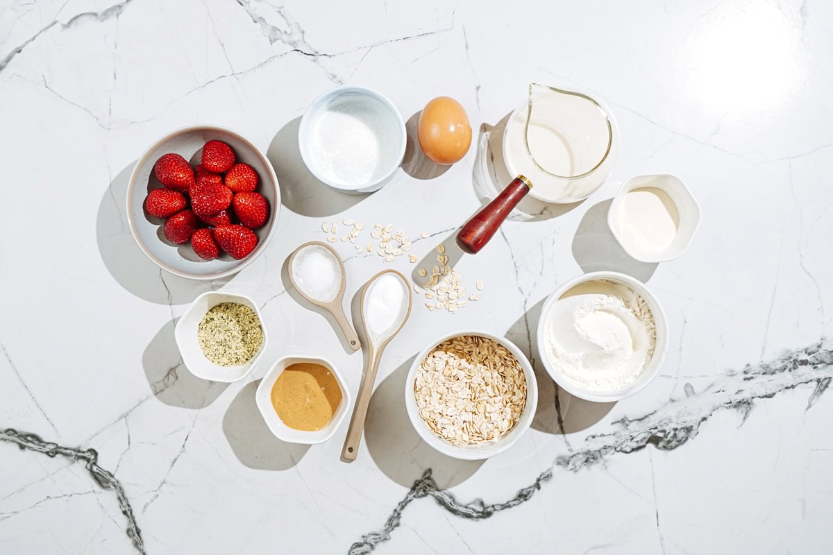 Fluffy protein powder pancakes ingredients like flour, protein powder, sugar, egg, soy milk, rolled oats, nut butter, hemp seeds, strawberries etc | Hurry The Food Up

