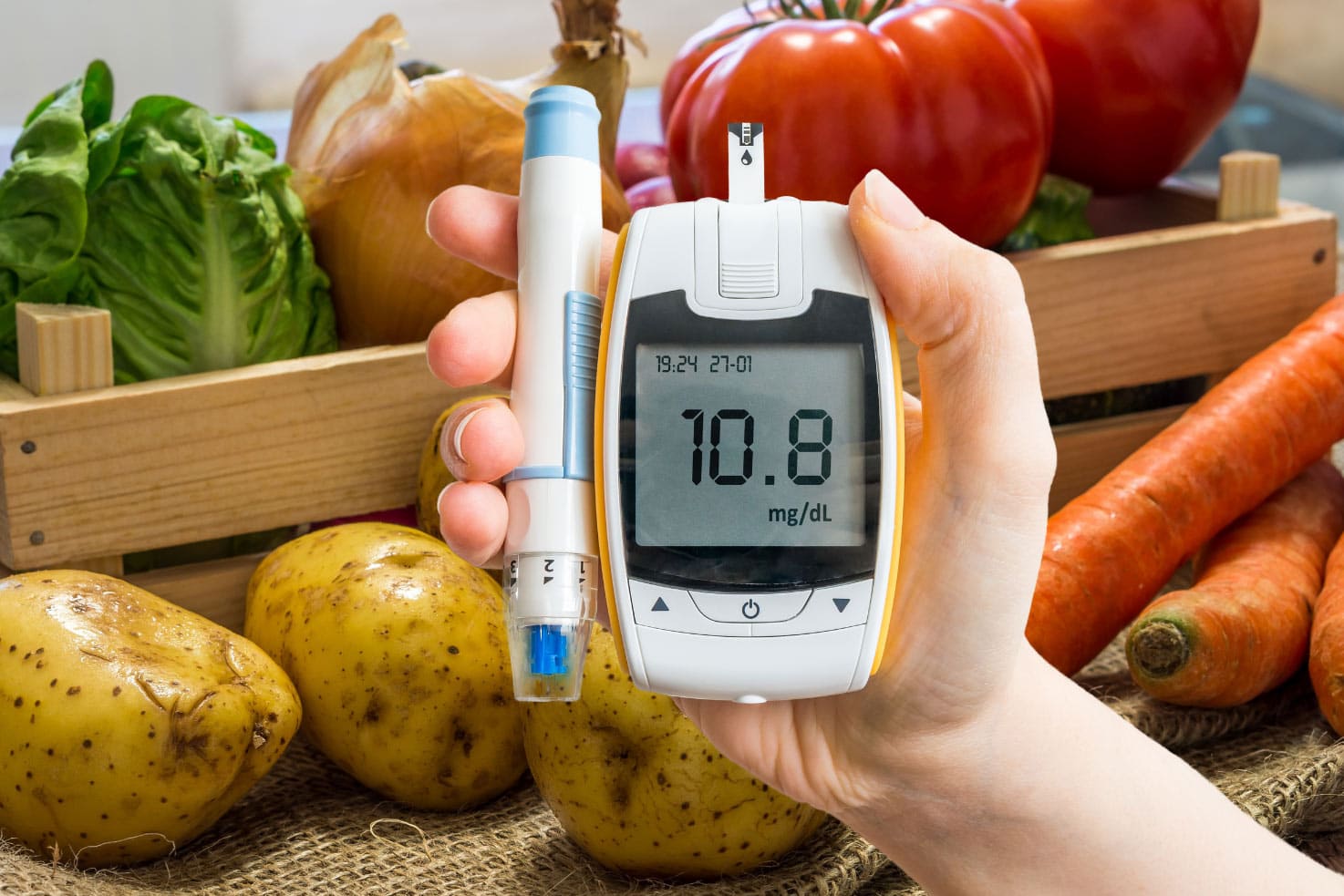 Hand holds glucometer for measuring glucose level | Hurry The Food Up
