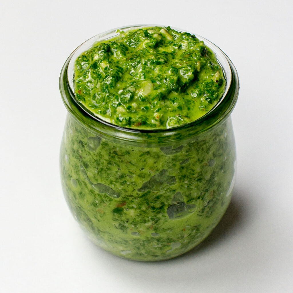 Green pesto on white background