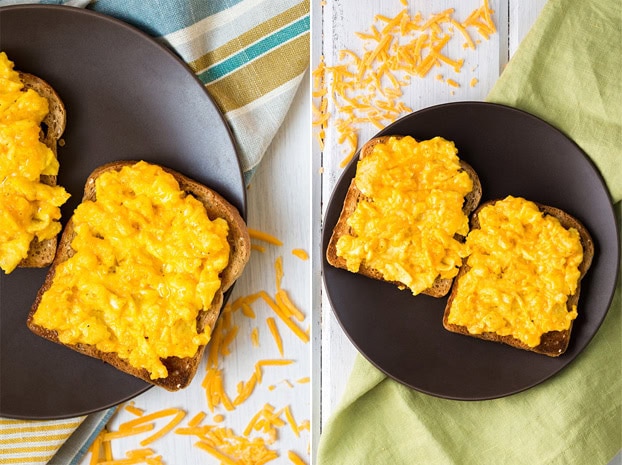 Bread with perfect scrambled eggs with cheese lie on the black plate that is on the napkin | Hurry The Food Up