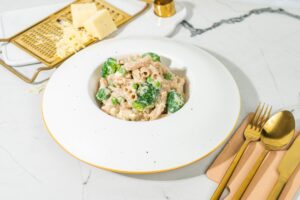 A helping of pasta and veggies in cheese sauce in a white bowl | Hurry The Food Up