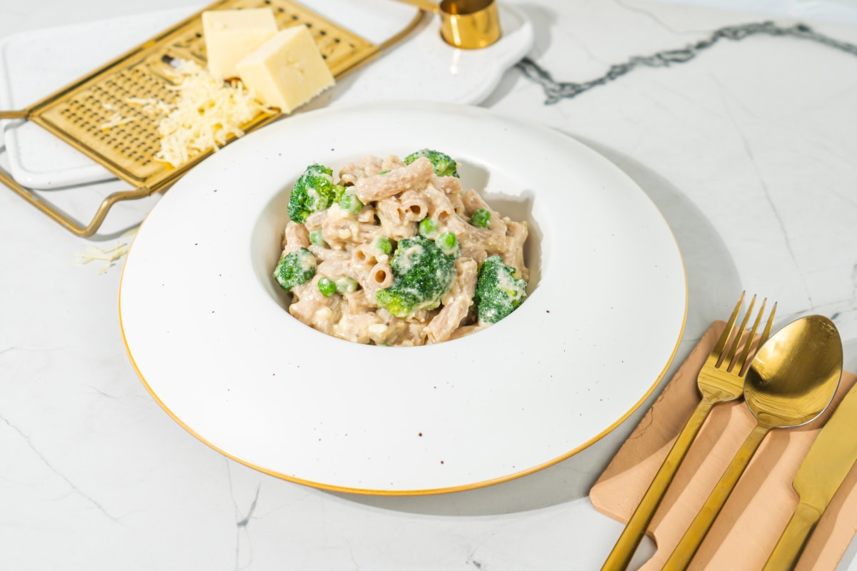 A helping of pasta and veggies in cheese sauce in a white bowl | Hurry The Food Up