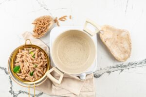 An empty pan and a sieve of cooked broccoli peas and pasta | Hurry The Food Up