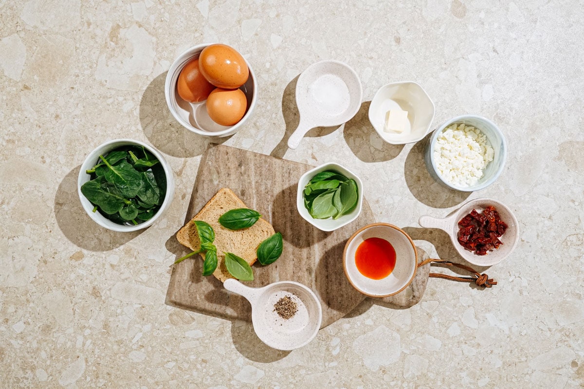 High Protein Omelette ingredients like eggs, baby spinach, butter, feta, sundried-tomatoes, basil leaves, etc | Hurry The Food Up