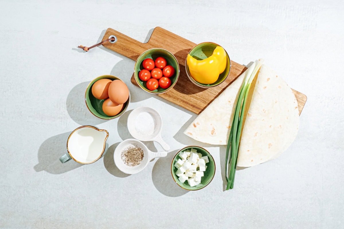 High-protein tortilla quiche ingredients like scallion, tortillas, eggs, tomatoes, milk, cheese etc  | Hurry The Food Up