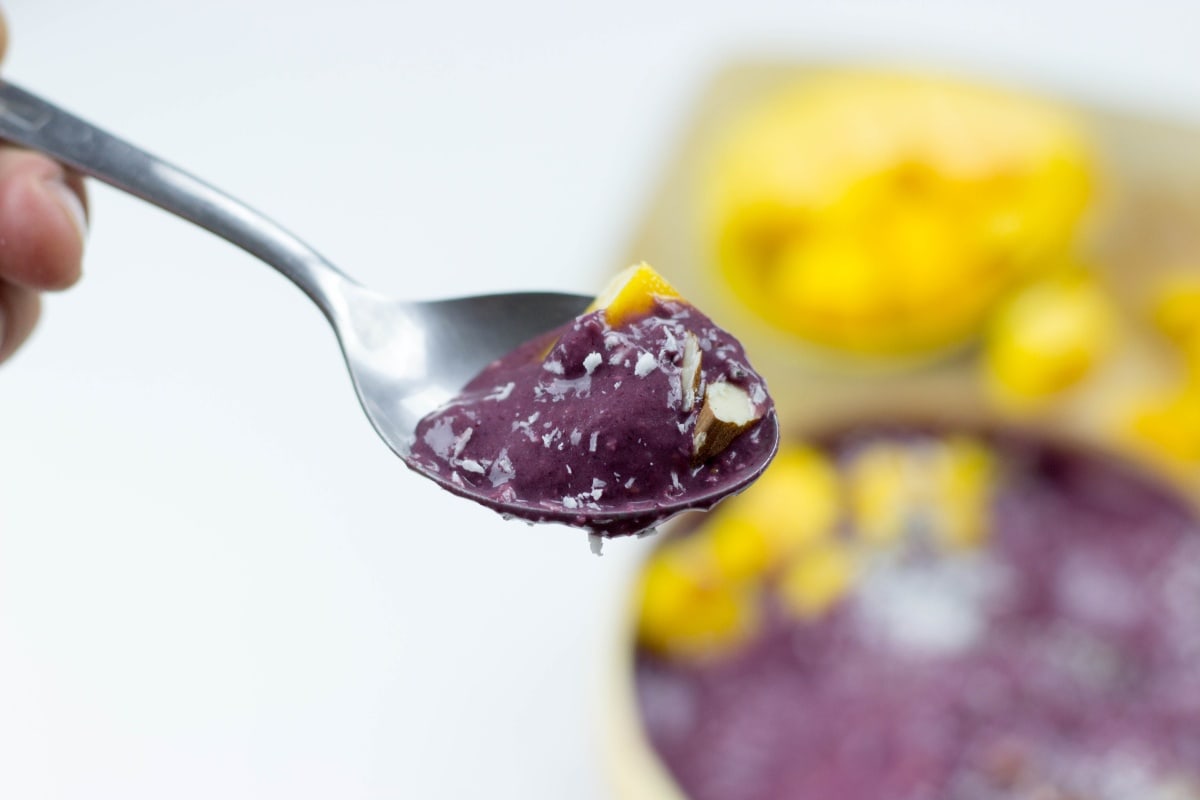 A spoonful of acai held up in front of a bowl of acai | Hurry The Food Up