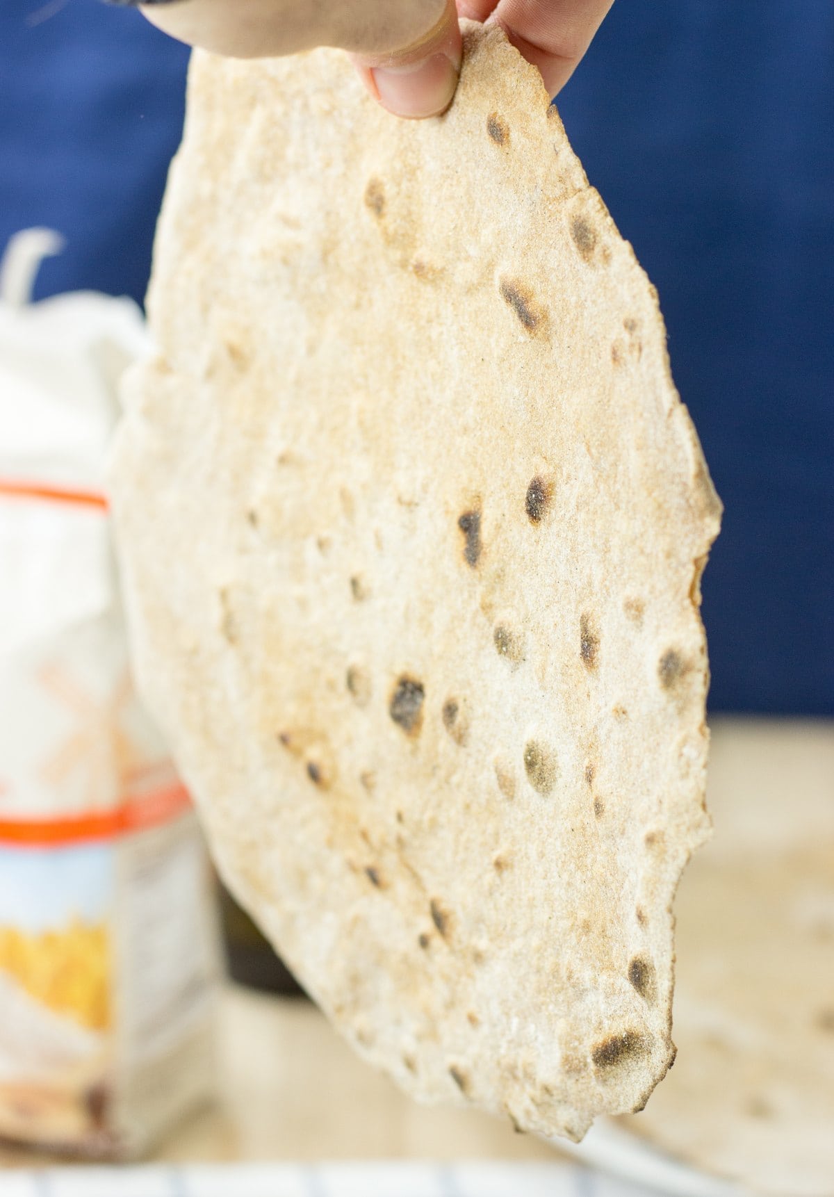 А piece of tortilla is in hand | Hurry The Food Up