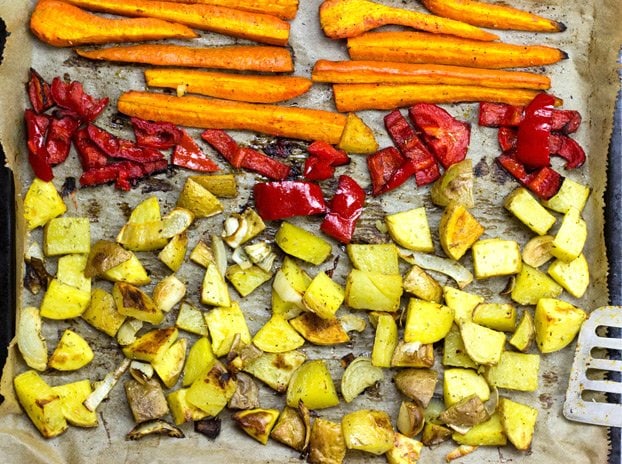 Roasted potatoes, carrots and bell pepper are laid on the baking tray | Hurry The Food Up