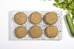 Six lentil patties on a marble slate, ready to be fried | Hurry The Food Up