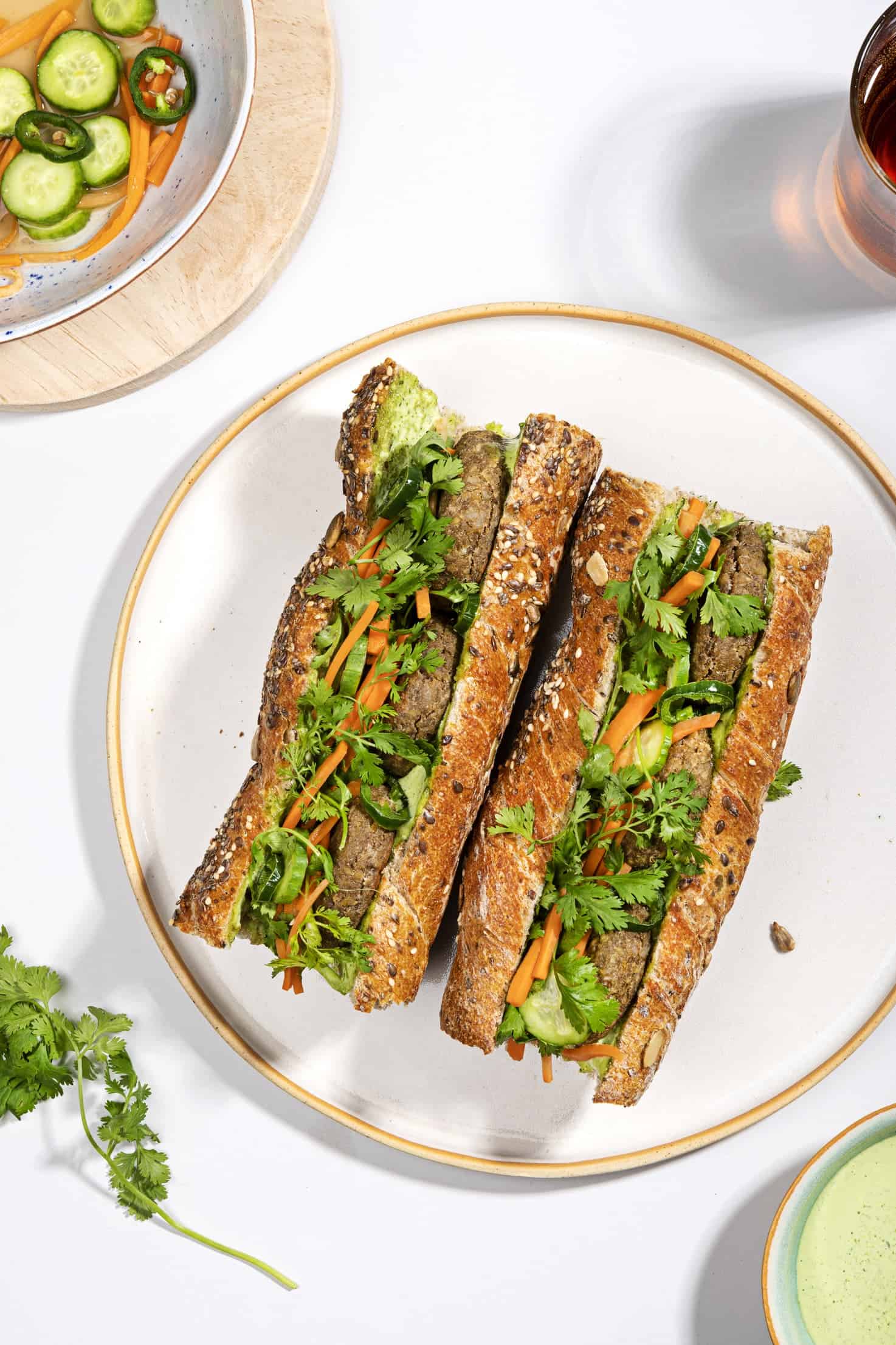 A bird's eye view of two lentil banh mi sandwiches on a plate | Hurry The Food Up