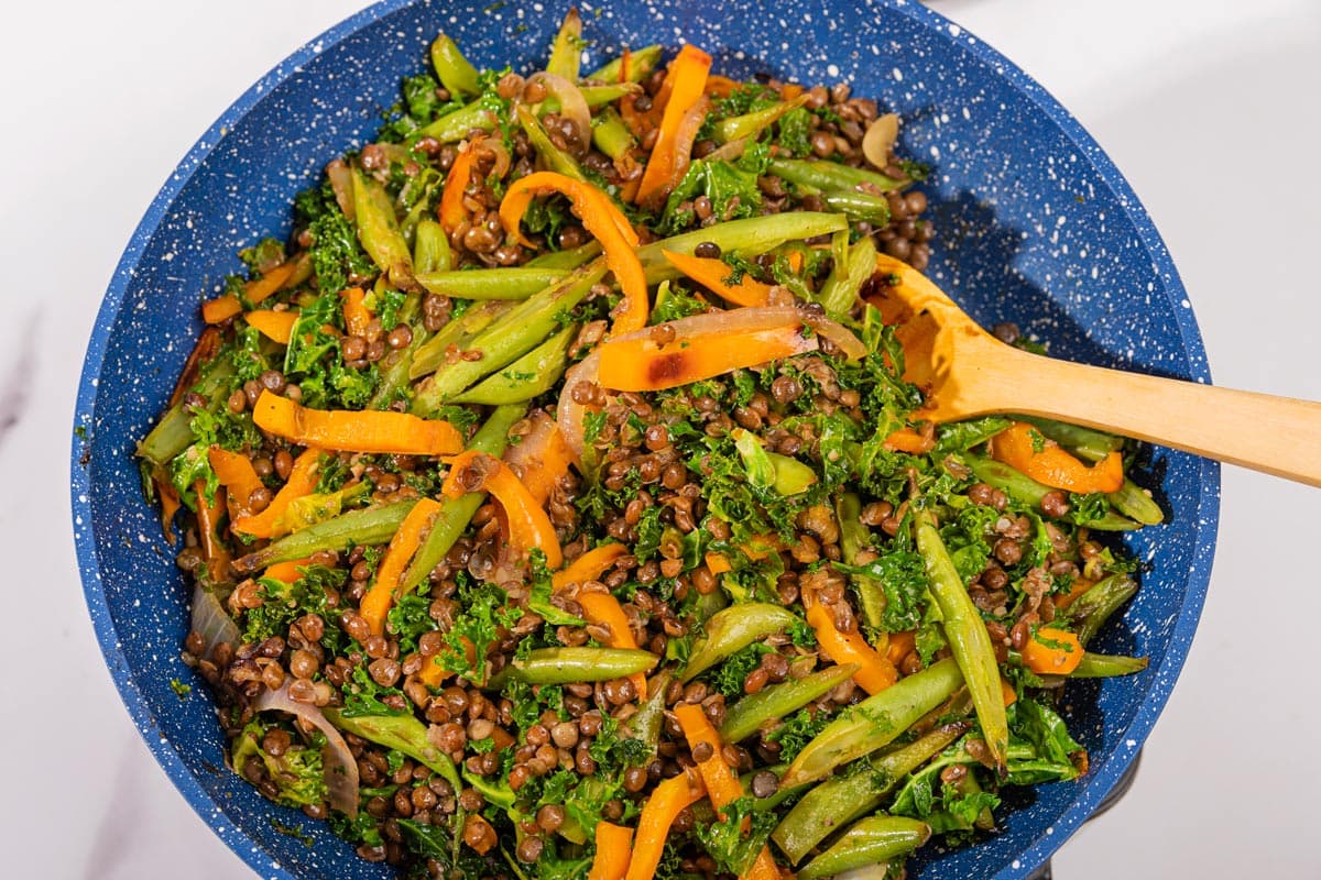 Lentils with Vegetables in Tahini Sauce are cooking in the blue pan | Hurry The Food Up