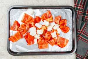The process of adding the bell pepper, tomato, low fat feta in a small baking pan | Hurry The Food Up