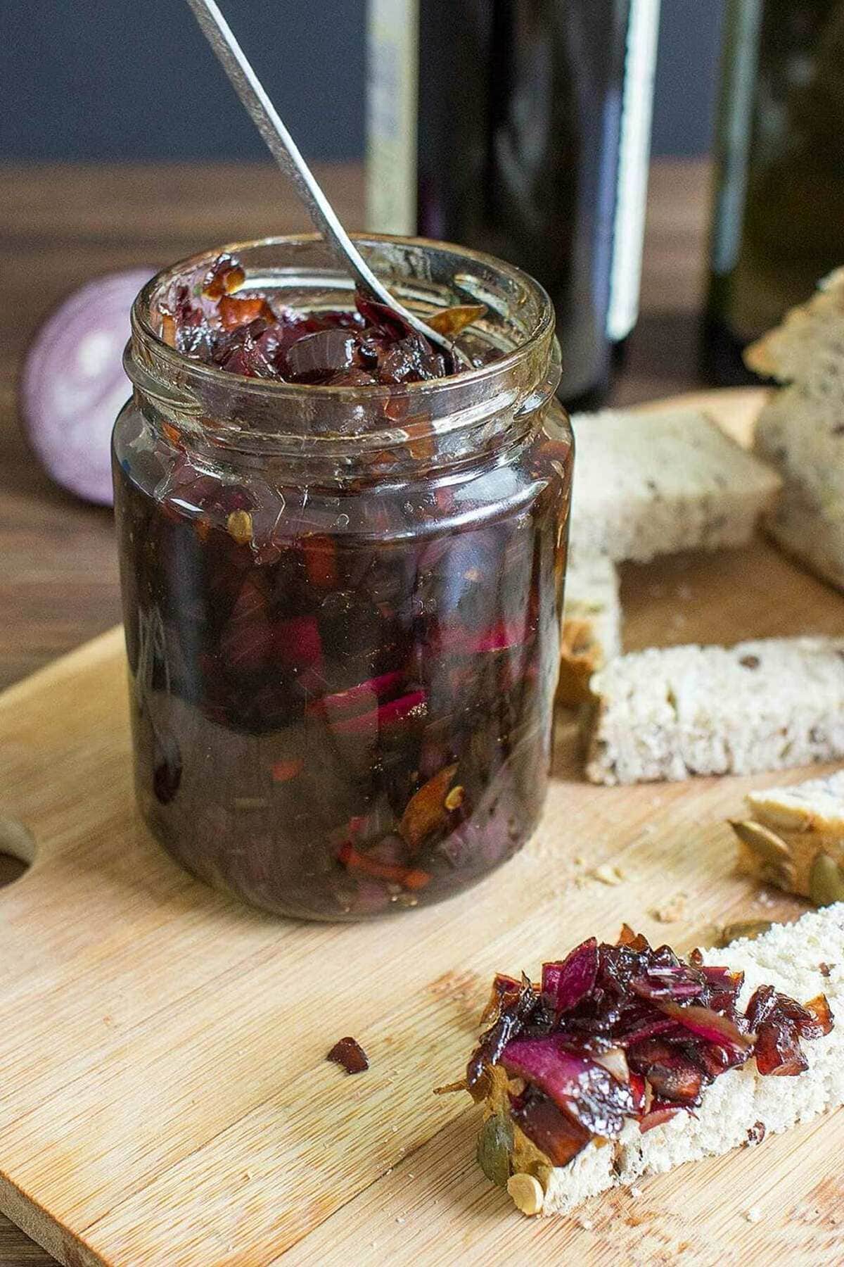 Onion Chutney is in the jar that is on the chopping board with pieces of bread | Hurry The Food Up