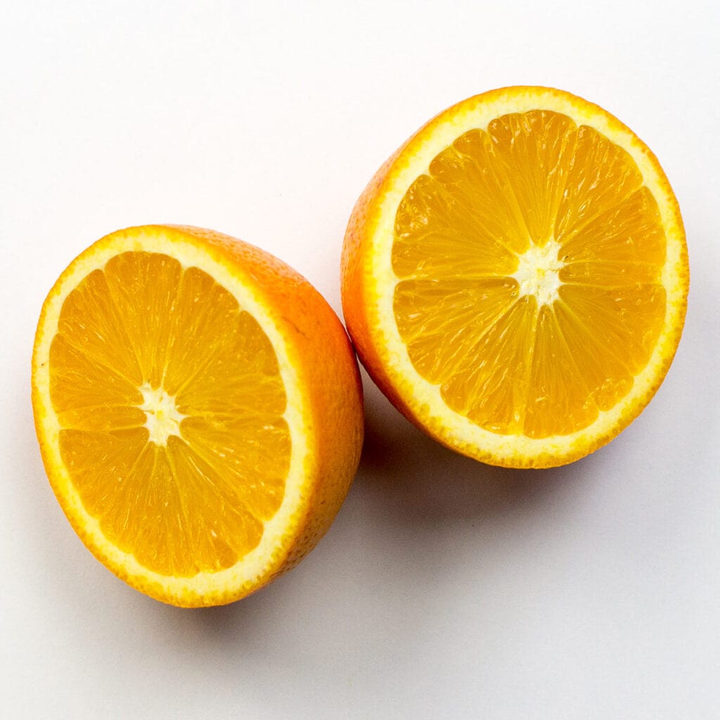 Two orange halves on white background