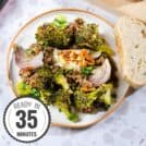 The Oven Roasted Broccoli Halloumi is served on a white plate with a bread slice with a time stamp in the bottom left hand corner | Hurry The Food Up