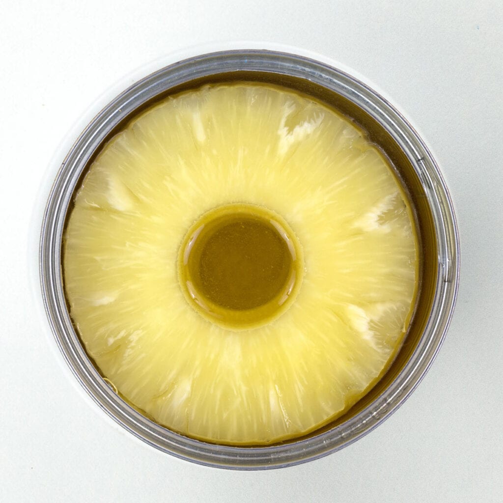 A can of pineapple on white surface