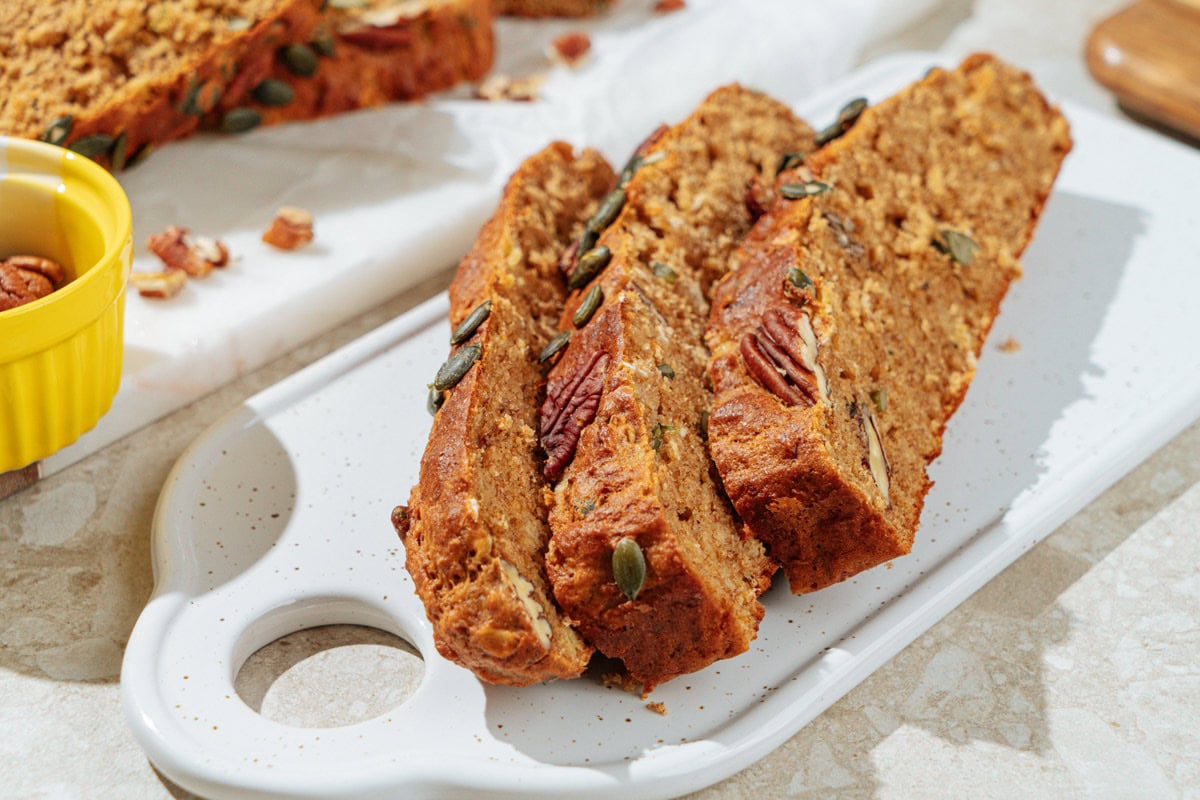The white board with the three pieces of deeply golden brown protein banana bread on it | Hurry The Food Up