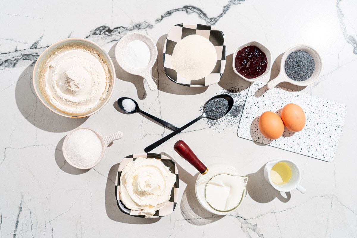 Protein muffins ingredients like poppy seeds, eggs, oil, milk, cream cheese, sugar, flour, baking soda, protein powder, jam etc | Hurry The Food Up