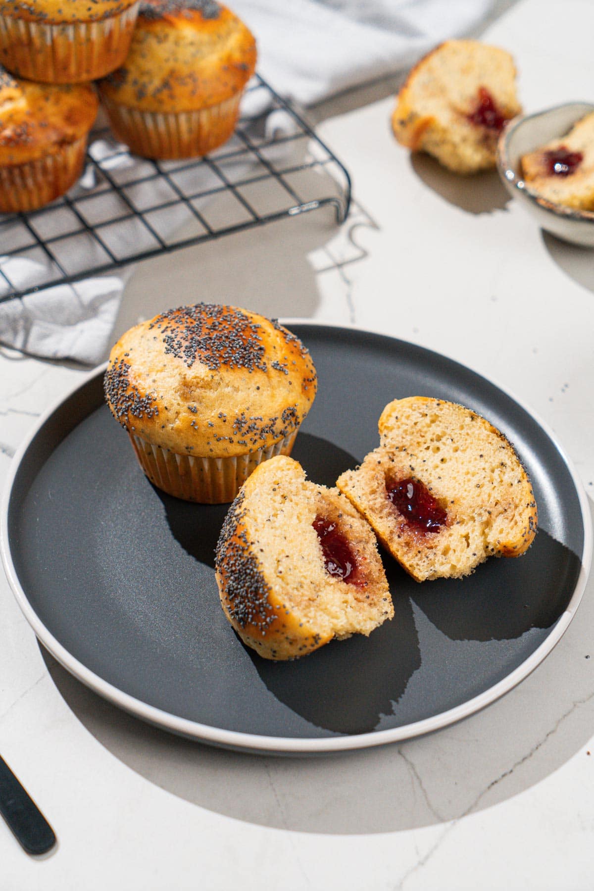 Protein muffins are on the dark plate. Near it there are some whole muffins on a metal grid as well etc | Hurry The Food Up
