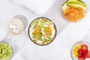 A bird’s eye view of a jar of noodle salad, and some smaller plates of prepared ingredients for the salad| Hurry The Food Up