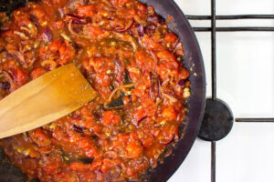 There is a pan with steamed vegetables and a wooden spatula on the cooker | Hurry The Food Up