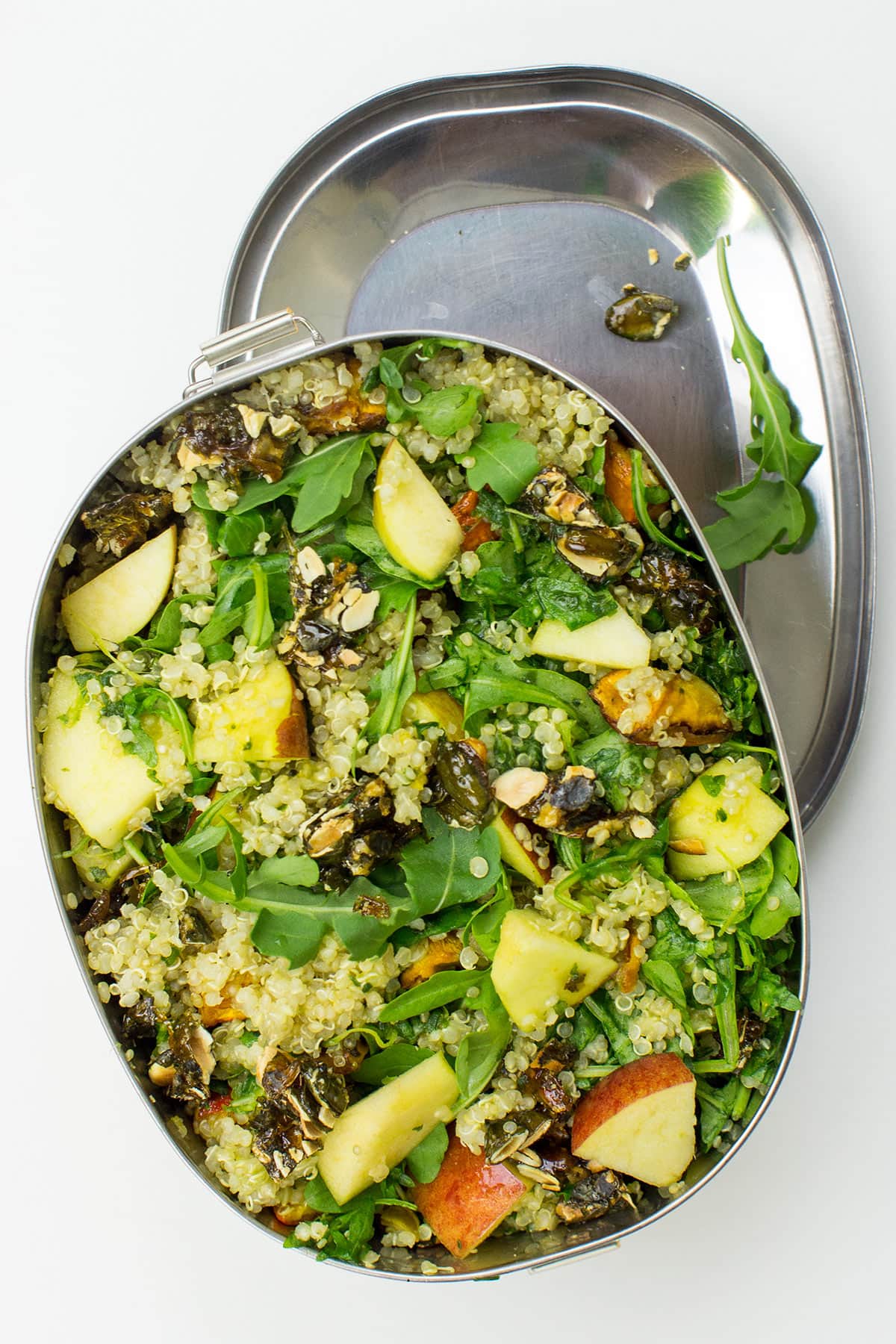 A metal bowl of Roasted Pumpkin Quinoa Salad with Rocket Pesto